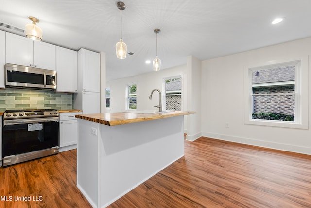 2312 6th Ave, Gulfport, MS 39501 - kitchen with butcher block countertops, stainless steel appliances, a sink, white cabinets, and recessed lighting