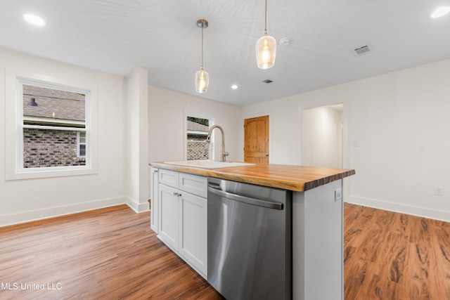2312 6th Ave, Gulfport, MS 39501 - kitchen with stainless steel dishwasher, a sink, wooden counters, light wood finished floors, and white cabinets