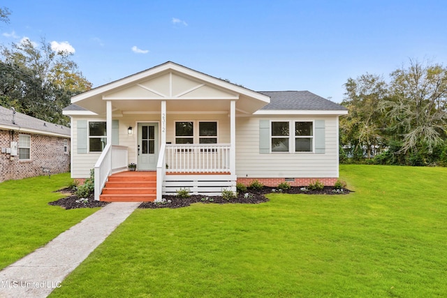 bungalow-style house featuring covered porch and a front yard