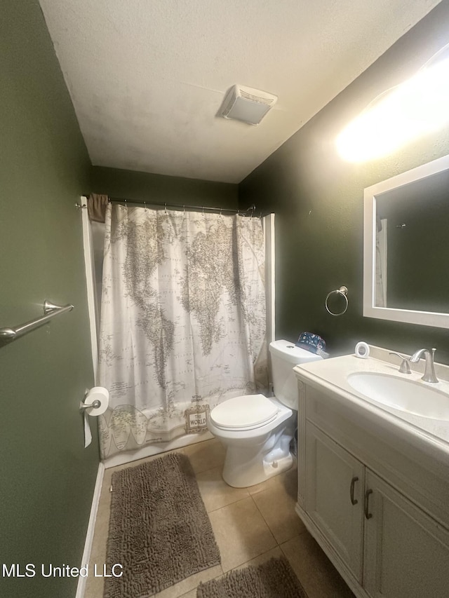 full bathroom featuring toilet, vanity, and tile patterned flooring