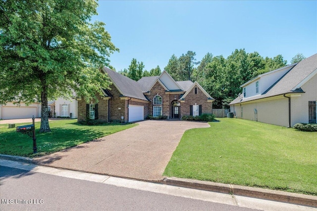 3753 Kenton Dr, Southaven, MS 38672 - view of front of house with a garage, driveway, a front yard, cooling unit, and brick siding