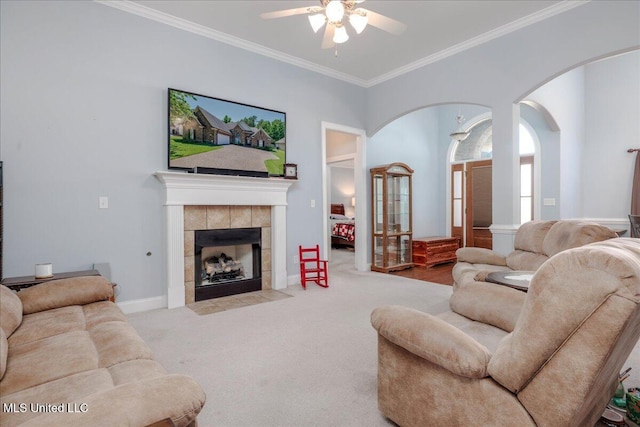 3753 Kenton Dr, Southaven, MS 38672 - carpeted living area with ceiling fan, ornamental molding, arched walkways, and a tiled fireplace
