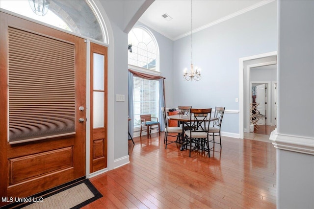 3753 Kenton Dr, Southaven, MS 38672 - entrance foyer featuring crown molding, a chandelier, hardwood / wood-style flooring, a towering ceiling, and baseboards