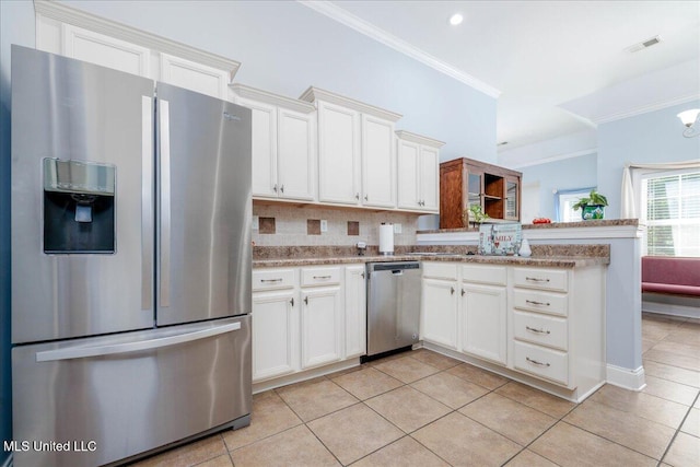 3753 Kenton Dr, Southaven, MS 38672 - kitchen featuring stainless steel appliances, ornamental molding, light tile patterned flooring, white cabinets, and backsplash