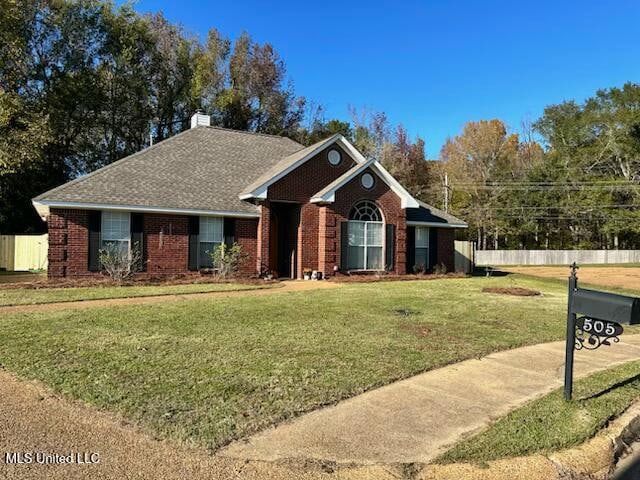 ranch-style home with a front yard