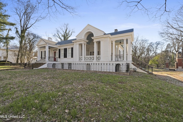 neoclassical / greek revival house with a chimney, stairway, a porch, and a front yard