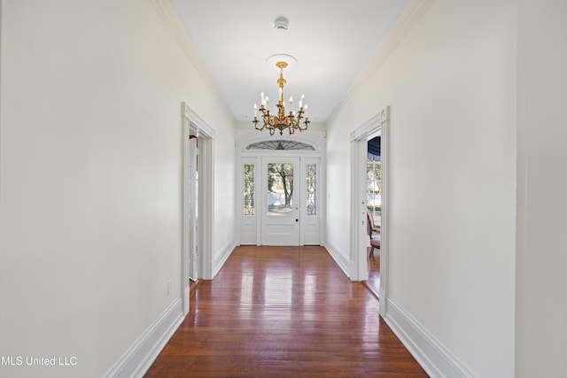 doorway with an inviting chandelier, baseboards, and dark wood-style flooring