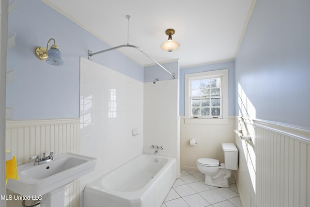 bathroom with toilet, bathing tub / shower combination, wainscoting, tile patterned floors, and crown molding