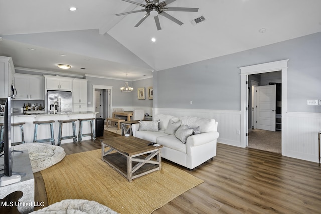 living room featuring dark hardwood / wood-style floors, lofted ceiling with beams, and ceiling fan with notable chandelier