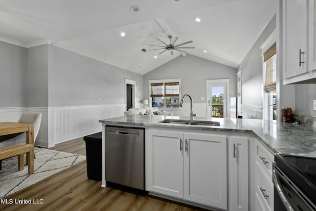 kitchen featuring dark hardwood / wood-style flooring, white cabinetry, stainless steel dishwasher, vaulted ceiling, and sink