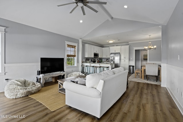 living room featuring dark hardwood / wood-style floors, lofted ceiling with beams, sink, and ceiling fan with notable chandelier