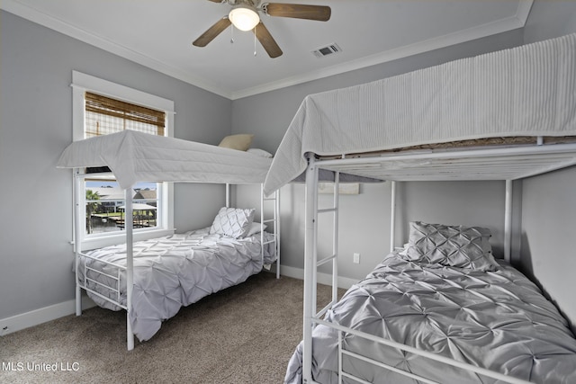 carpeted bedroom with ceiling fan and crown molding