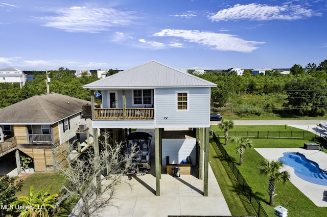 rear view of house with a lawn and a carport