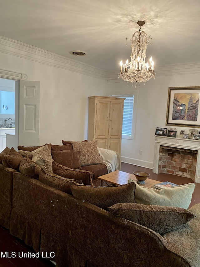 living room featuring baseboards, visible vents, ornamental molding, wood finished floors, and a chandelier