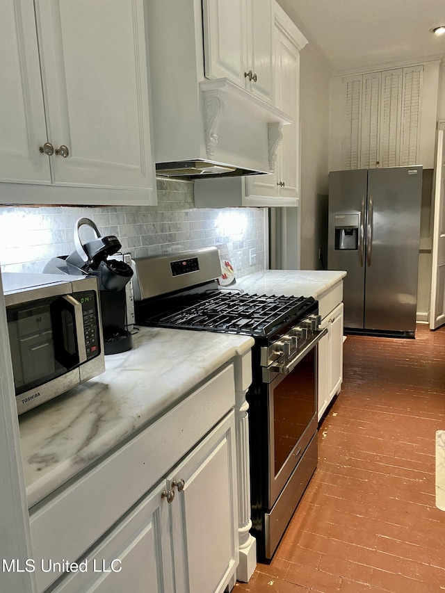 kitchen featuring white cabinetry, stainless steel appliances, and decorative backsplash