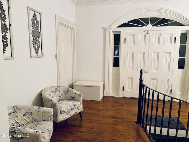 living area with crown molding and wood finished floors