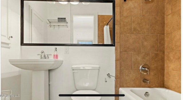 full bathroom featuring shower / bath combination with curtain and toilet