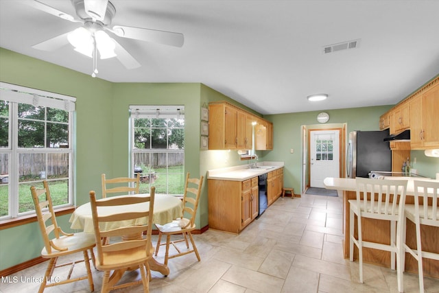 8809 Old Walnut Rd, Ocean Springs, MS 39564 - kitchen with dishwasher, light countertops, plenty of natural light, and freestanding refrigerator