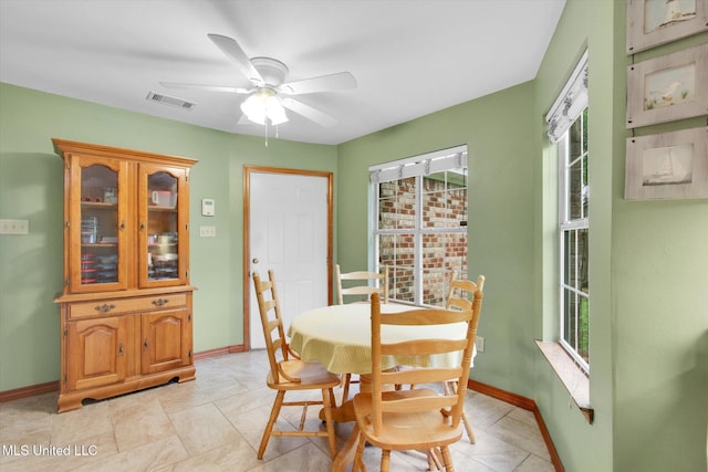 8809 Old Walnut Rd, Ocean Springs, MS 39564 - dining room with plenty of natural light, ceiling fan, and baseboards