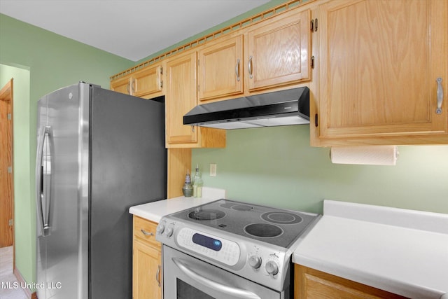 8809 Old Walnut Rd, Ocean Springs, MS 39564 - kitchen featuring under cabinet range hood, electric stove, freestanding refrigerator, light countertops, and light brown cabinetry