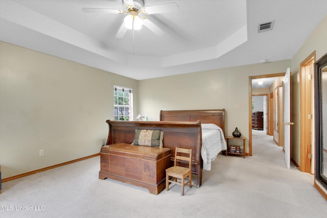 8809 Old Walnut Rd, Ocean Springs, MS 39564 - bedroom with a tray ceiling, light carpet, a ceiling fan, and baseboards