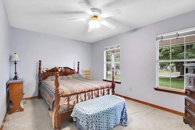 8809 Old Walnut Rd, Ocean Springs, MS 39564 - bedroom with light carpet, baseboards, a textured ceiling, and ceiling fan