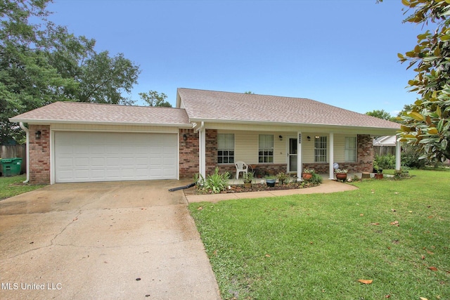 8809 Old Walnut Rd, Ocean Springs, MS 39564 - single story home with concrete driveway, brick siding, a garage, a front lawn, and a porch