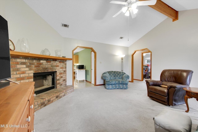 8809 Old Walnut Rd, Ocean Springs, MS 39564 - living area with ceiling fan, carpet floors, a fireplace, baseboards, and arched walkways