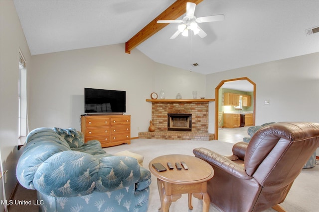 8809 Old Walnut Rd, Ocean Springs, MS 39564 - living room featuring light colored carpet, a ceiling fan, arched walkways, and a fireplace