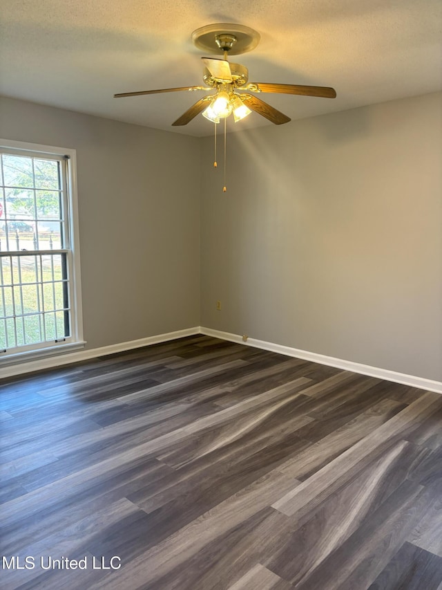 empty room featuring ceiling fan, dark hardwood / wood-style flooring, and a textured ceiling