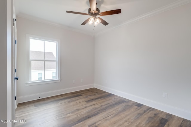 unfurnished room featuring ornamental molding, ceiling fan, baseboards, and wood finished floors