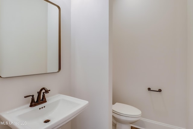 half bathroom with a sink and toilet