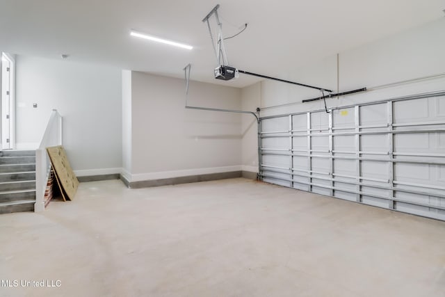 garage with a garage door opener and baseboards