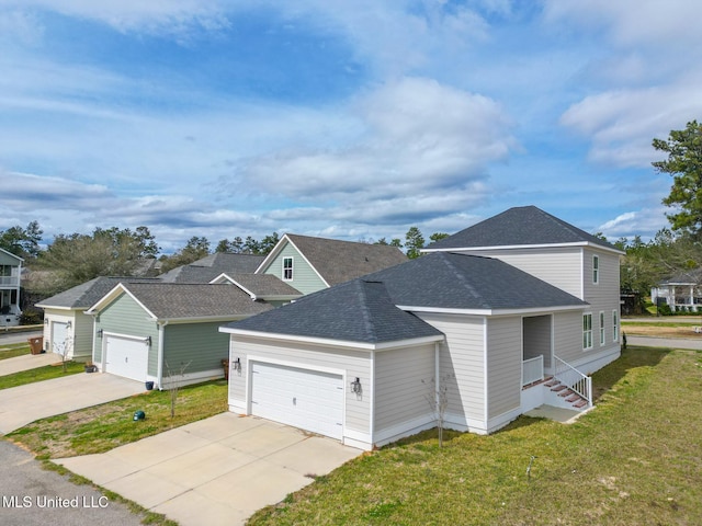 view of front of house featuring an attached garage, driveway, a front lawn, and roof with shingles