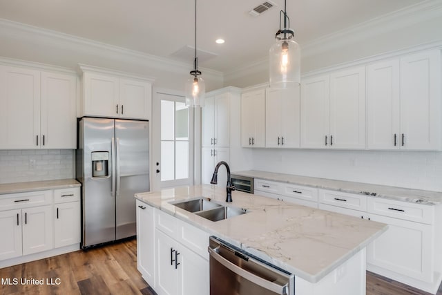 kitchen featuring visible vents, appliances with stainless steel finishes, crown molding, white cabinetry, and a sink