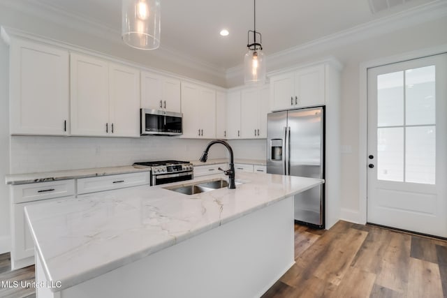 kitchen with white cabinets, ornamental molding, stainless steel appliances, and a sink