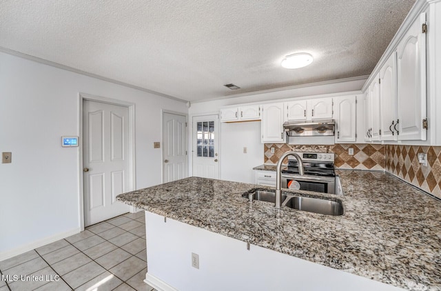 kitchen with kitchen peninsula, dark stone counters, stainless steel electric range, white cabinets, and light tile patterned flooring