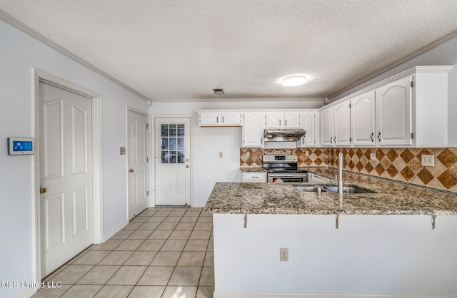 kitchen featuring light stone countertops, kitchen peninsula, white cabinetry, and electric stove