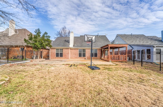 back of house with basketball court and a lawn