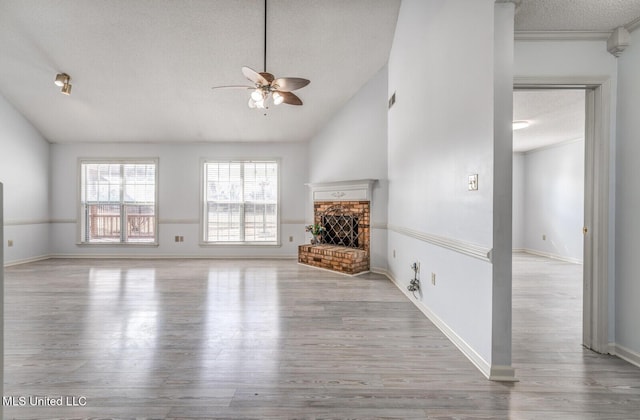 unfurnished living room with ceiling fan, light wood-type flooring, a fireplace, and lofted ceiling