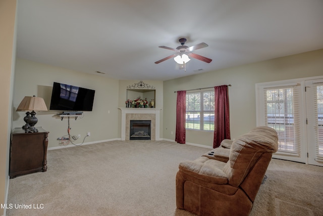 living room featuring ceiling fan, a healthy amount of sunlight, and light colored carpet