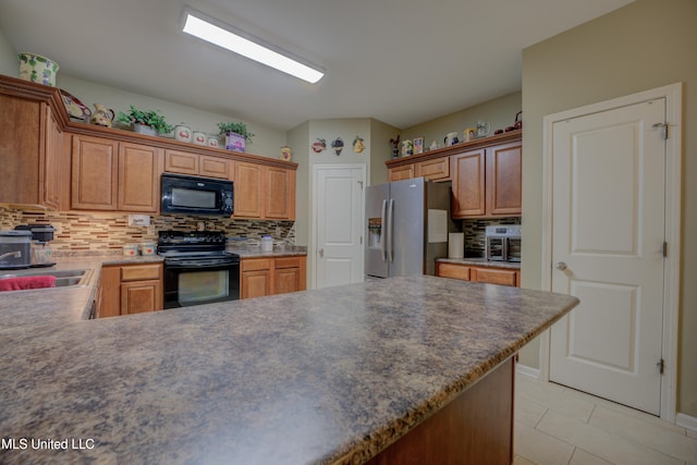 kitchen with black appliances, sink, and backsplash