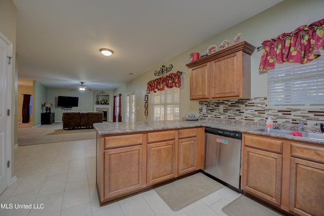 kitchen with dishwasher, sink, ceiling fan, decorative backsplash, and kitchen peninsula