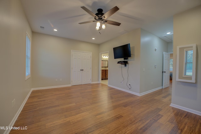 empty room with ceiling fan and hardwood / wood-style floors