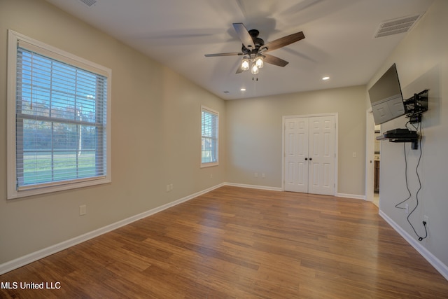 interior space with a closet, ceiling fan, and hardwood / wood-style floors