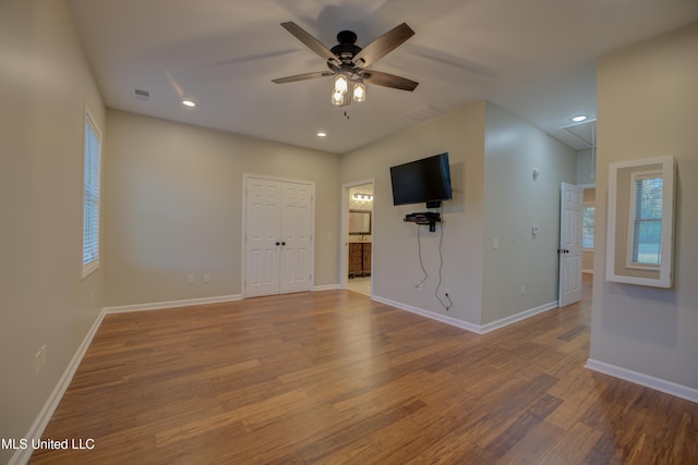 spare room featuring hardwood / wood-style floors and ceiling fan