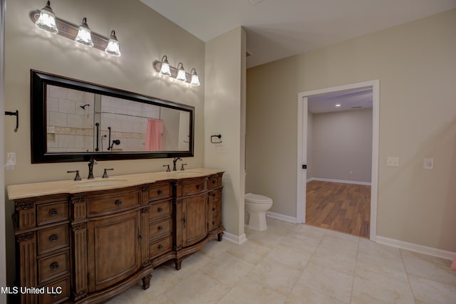 bathroom with a shower, hardwood / wood-style floors, vanity, and toilet