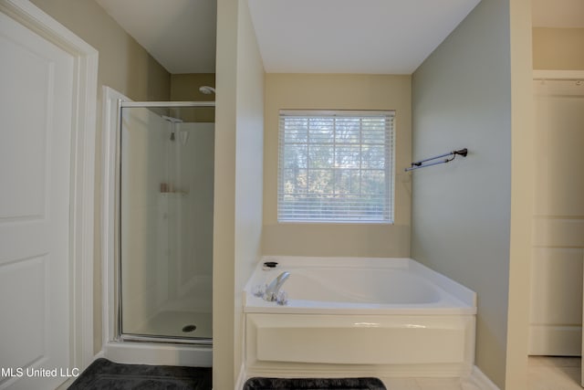 bathroom with tile patterned floors and separate shower and tub