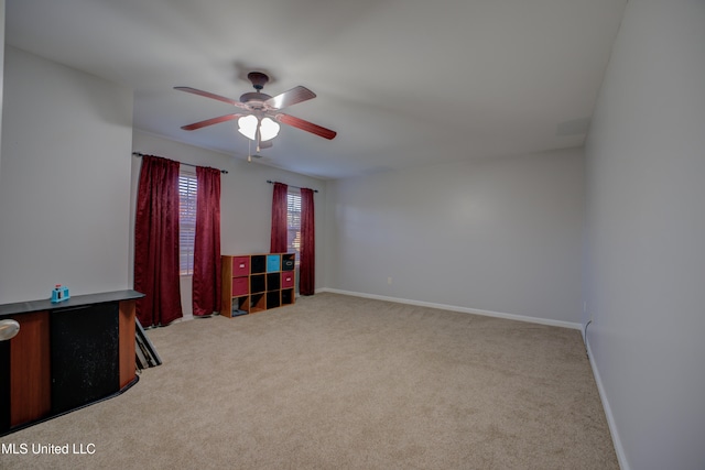 carpeted empty room featuring ceiling fan