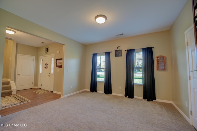 spare room featuring light colored carpet